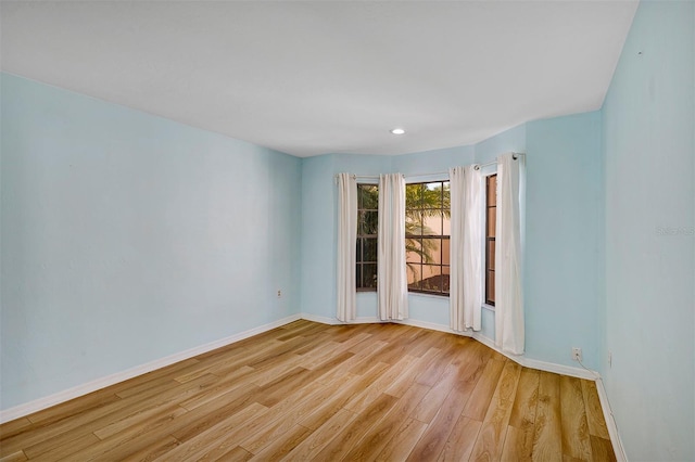 unfurnished room with light wood-type flooring