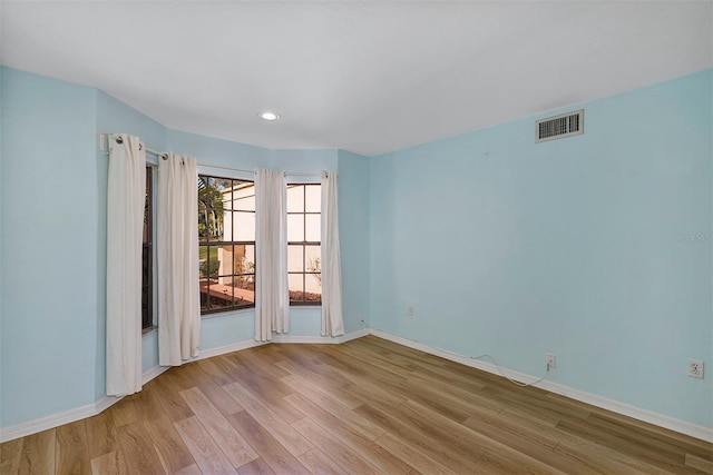 unfurnished room featuring light hardwood / wood-style floors