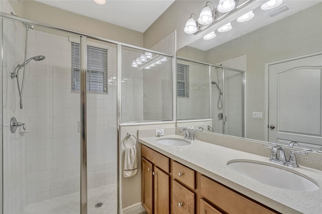 bathroom with vanity and a shower with door