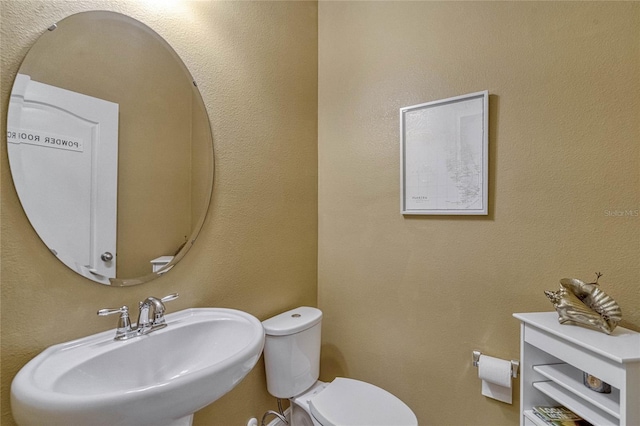 bathroom with toilet and sink