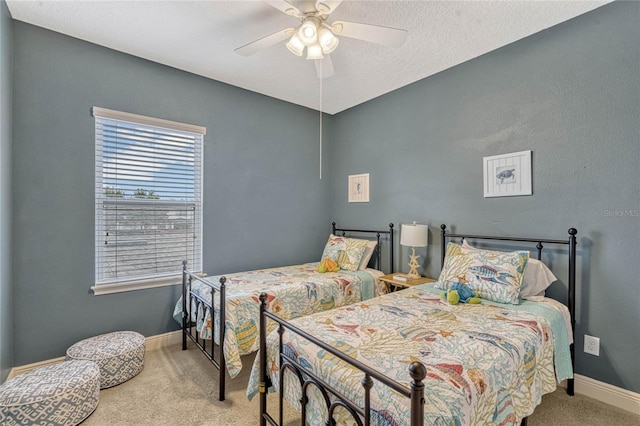 carpeted bedroom featuring a textured ceiling and ceiling fan