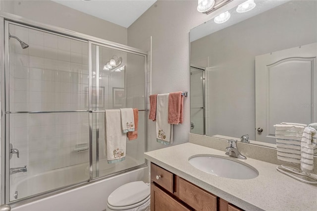 full bathroom with vanity, combined bath / shower with glass door, and toilet