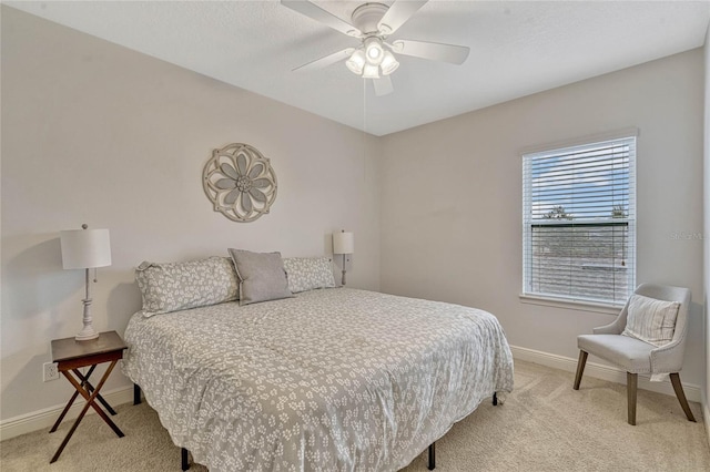 bedroom with light carpet and ceiling fan