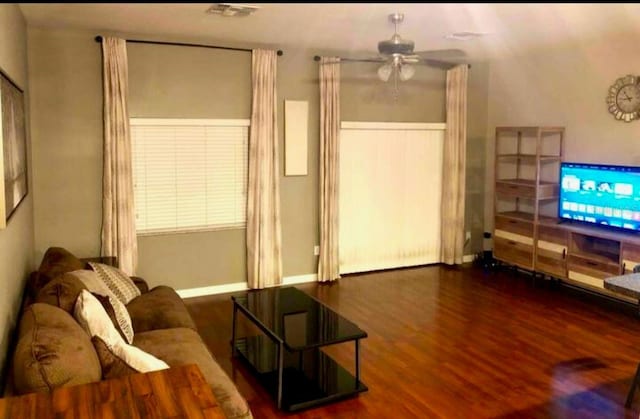 living room with ceiling fan and dark hardwood / wood-style floors