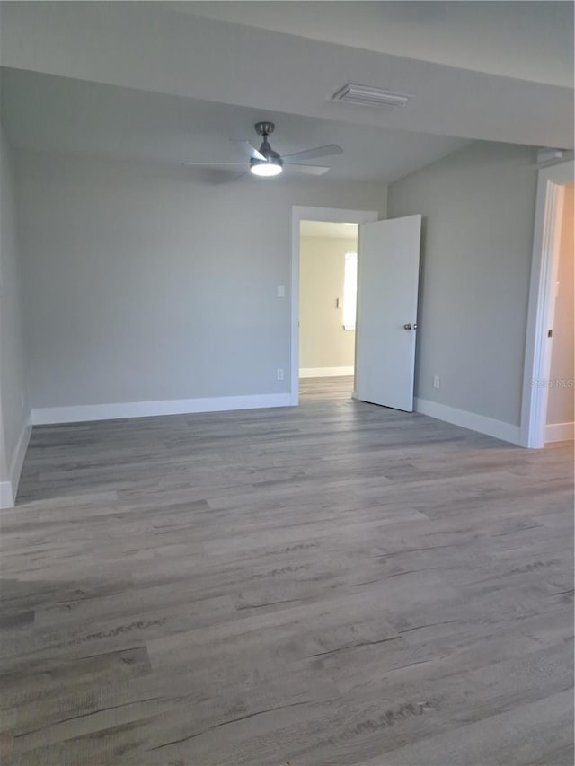 empty room featuring ceiling fan and light hardwood / wood-style flooring