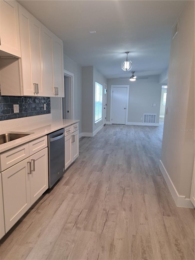 kitchen featuring white cabinets, decorative backsplash, light hardwood / wood-style floors, and dishwasher