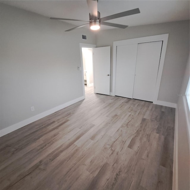 unfurnished bedroom featuring a closet, ceiling fan, and light hardwood / wood-style flooring