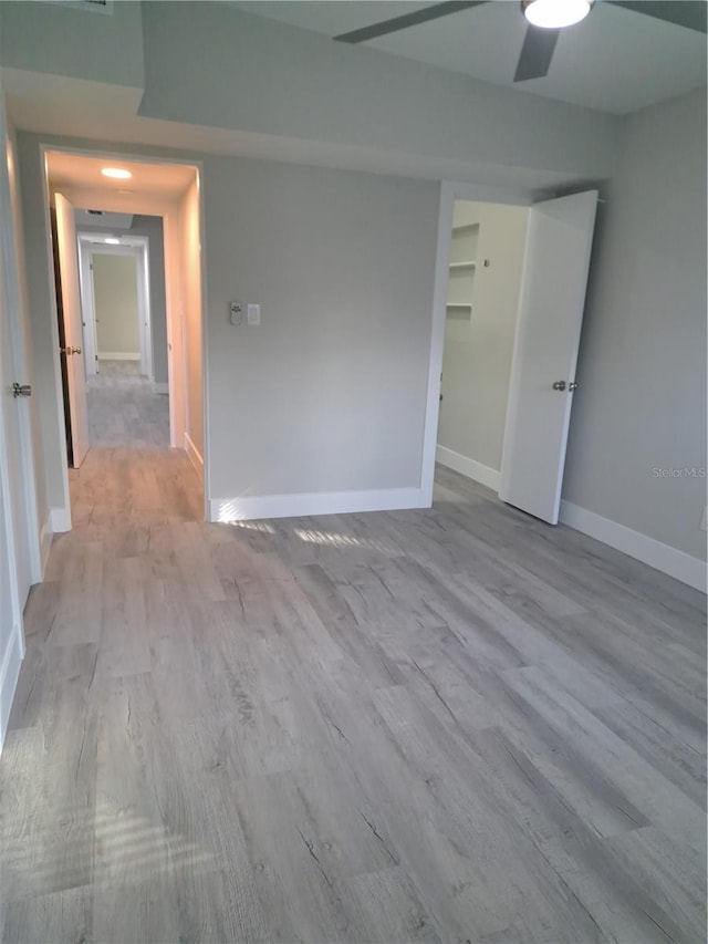 empty room featuring ceiling fan and light wood-type flooring