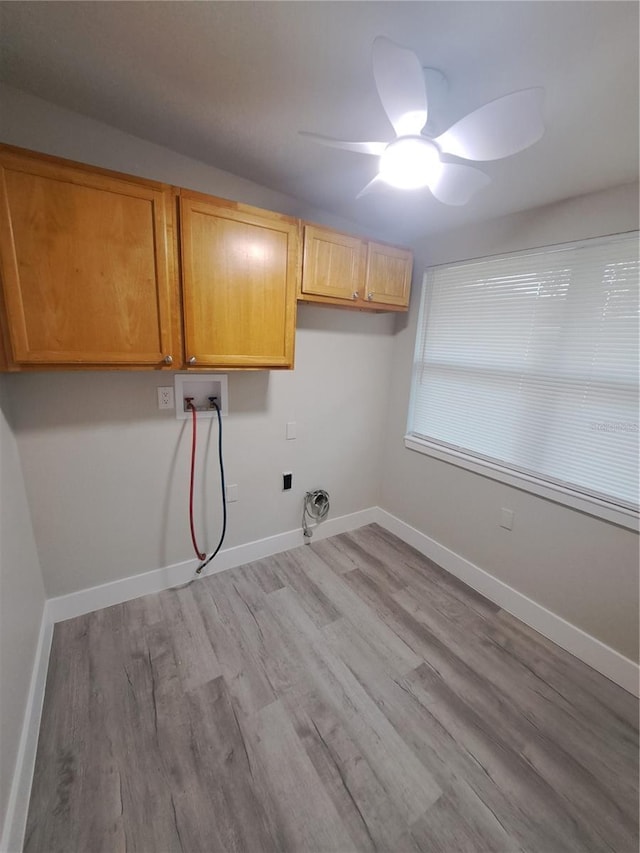 washroom featuring cabinets, ceiling fan, washer hookup, and light wood-type flooring