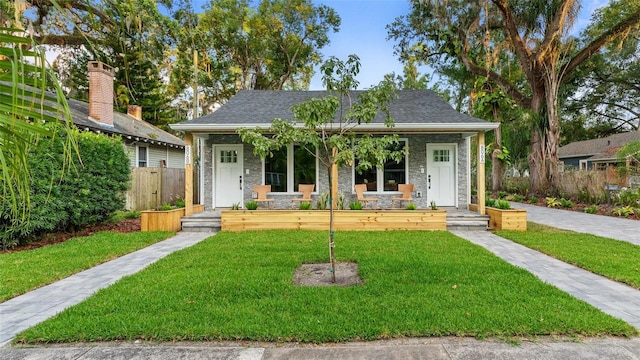 view of front of home with a porch and a front lawn