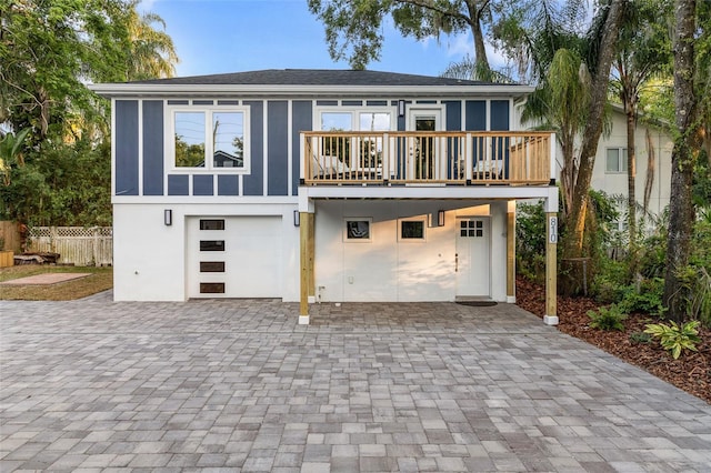 view of front facade with a balcony and a garage