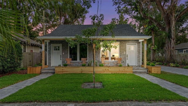 bungalow-style house with a porch and a lawn