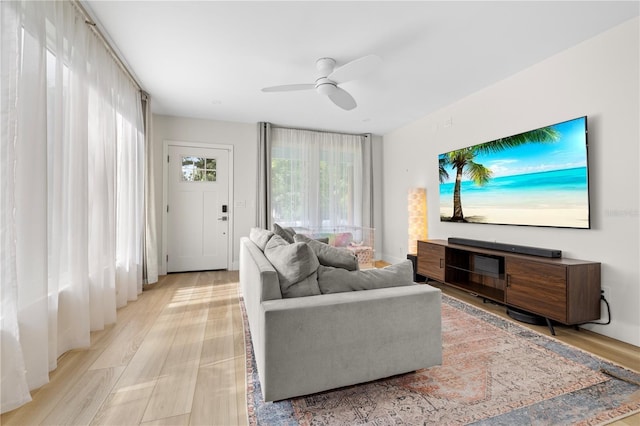 living room featuring light hardwood / wood-style floors and ceiling fan