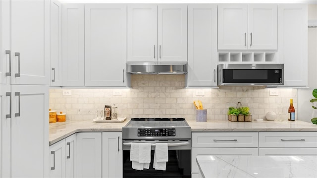 kitchen featuring white cabinetry, appliances with stainless steel finishes, light stone counters, and tasteful backsplash