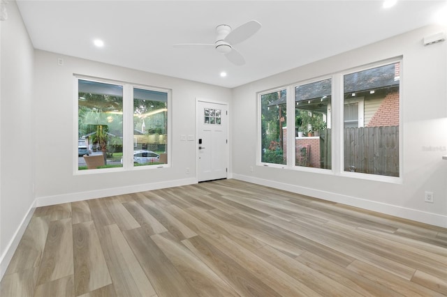 interior space featuring ceiling fan, a healthy amount of sunlight, and light hardwood / wood-style flooring