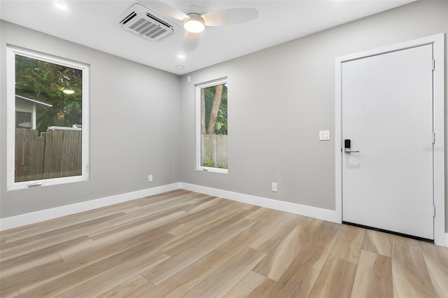 spare room with ceiling fan and light hardwood / wood-style flooring