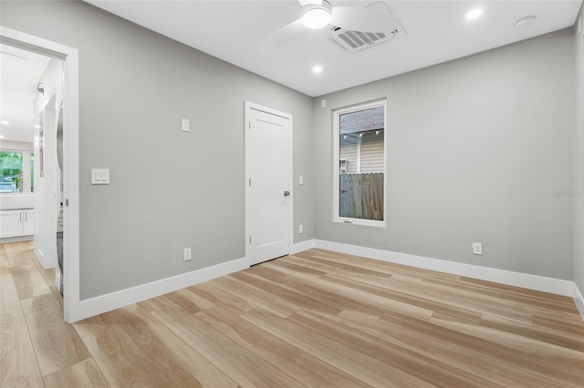 empty room with ceiling fan and light wood-type flooring