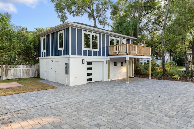 view of front facade with a garage and a deck