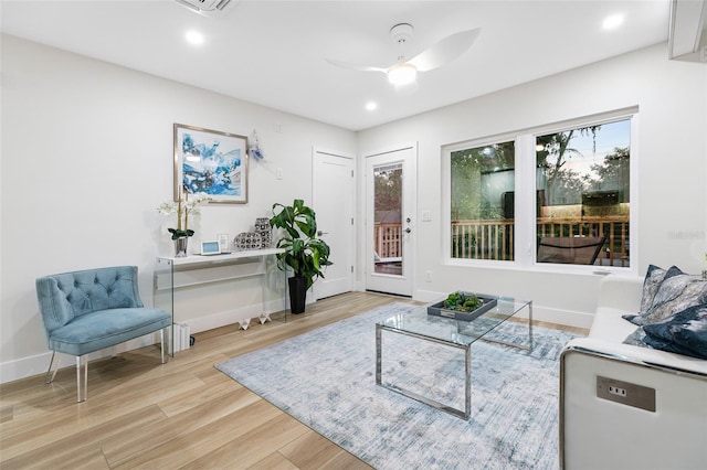 living room with ceiling fan and light wood-type flooring