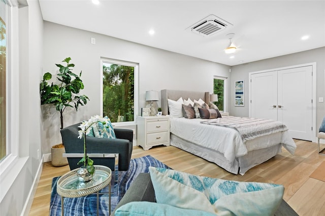 bedroom with ceiling fan and light hardwood / wood-style flooring