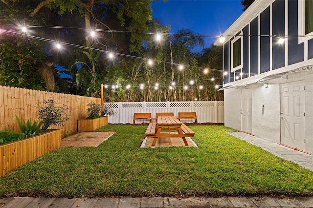 view of yard at twilight