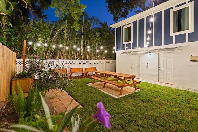 yard at night with a patio