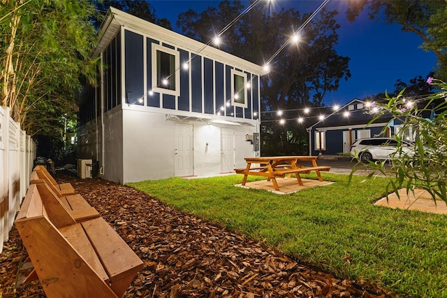 back house at night with a yard