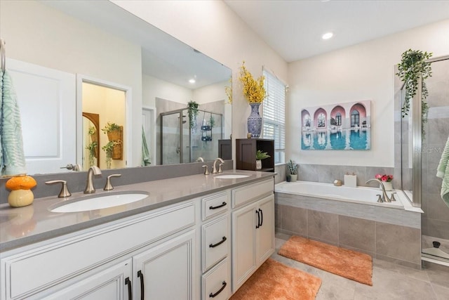 bathroom featuring tile patterned flooring, vanity, and separate shower and tub