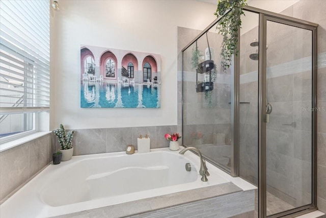 bathroom featuring separate shower and tub