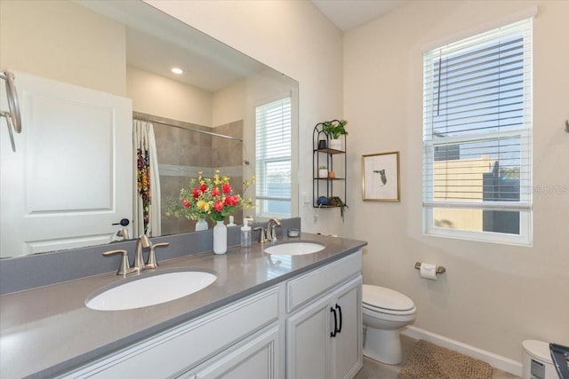 bathroom with vanity, curtained shower, and toilet