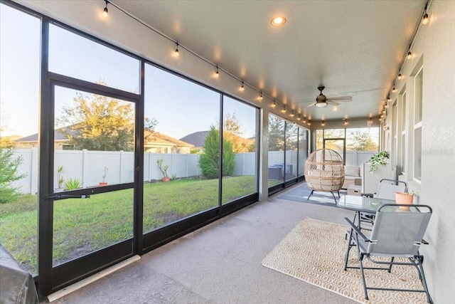 sunroom with ceiling fan and plenty of natural light