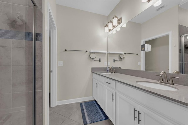 bathroom featuring vanity, an enclosed shower, and tile patterned floors