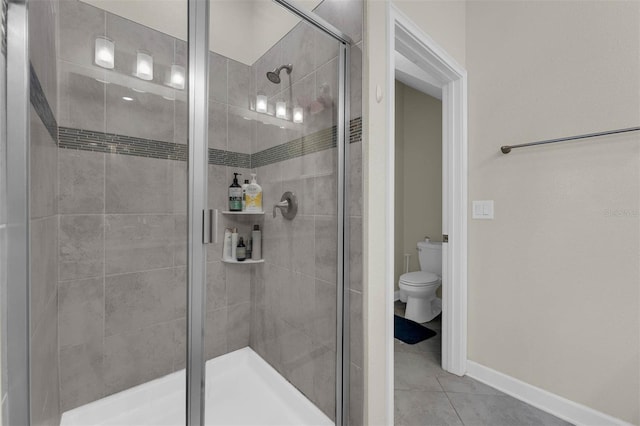 bathroom featuring tile patterned flooring, walk in shower, and toilet