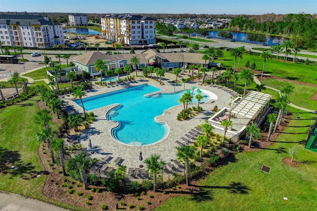 view of swimming pool featuring a patio and a water view