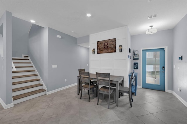 dining room featuring stairway, light tile patterned flooring, recessed lighting, and baseboards