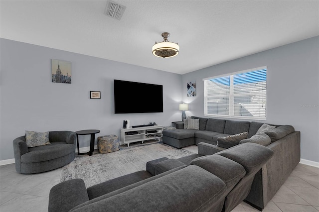 living room featuring visible vents, baseboards, and light tile patterned flooring
