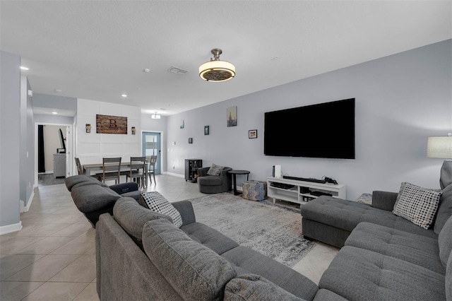 living room with light tile patterned floors, recessed lighting, and baseboards