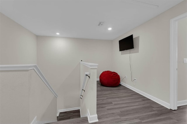 staircase with recessed lighting, visible vents, baseboards, and wood finished floors