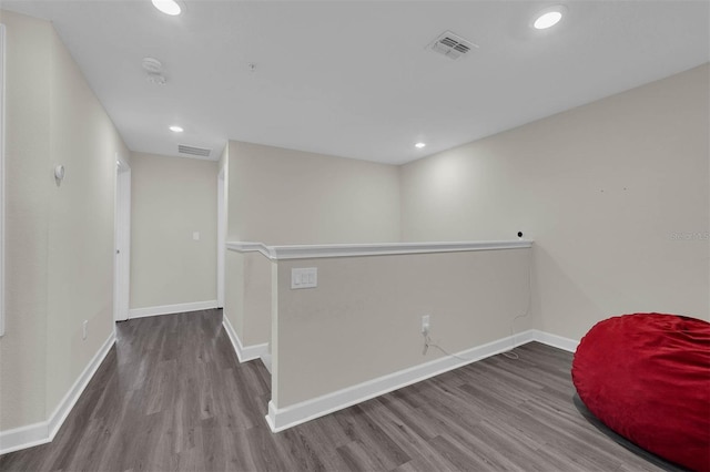 unfurnished room with recessed lighting, visible vents, baseboards, and wood finished floors
