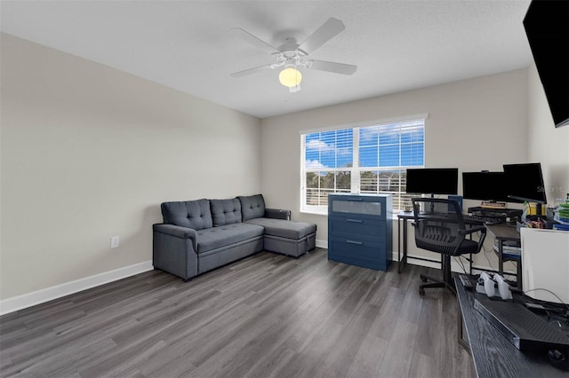 home office featuring baseboards, dark wood finished floors, and a ceiling fan