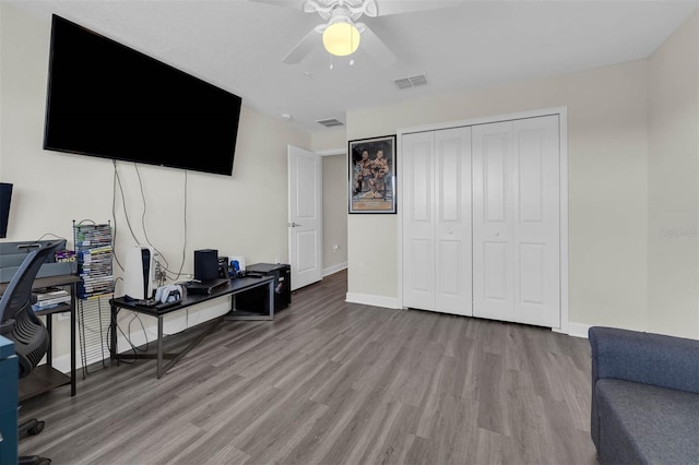 office featuring a ceiling fan, wood finished floors, visible vents, and baseboards