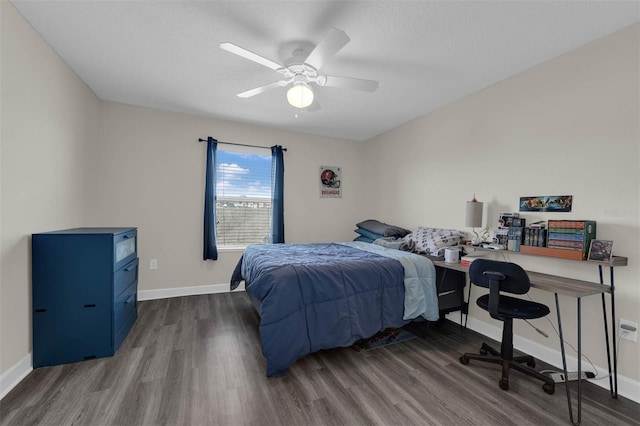 bedroom featuring wood finished floors, baseboards, and ceiling fan