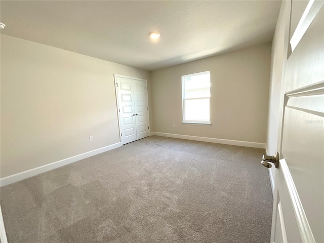 unfurnished bedroom with a closet and carpet