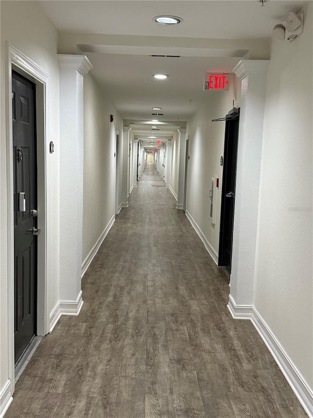 corridor with dark hardwood / wood-style flooring