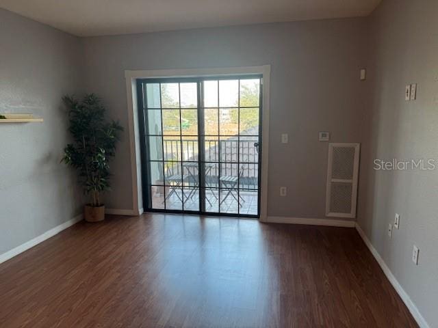 spare room with dark hardwood / wood-style flooring