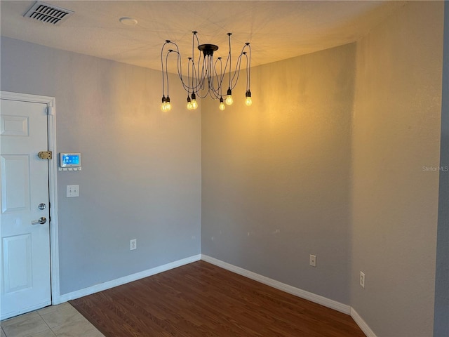 interior space featuring hardwood / wood-style floors and a notable chandelier