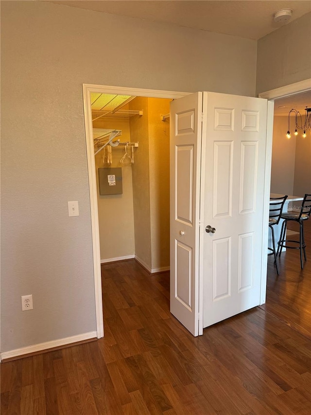 corridor featuring dark hardwood / wood-style flooring