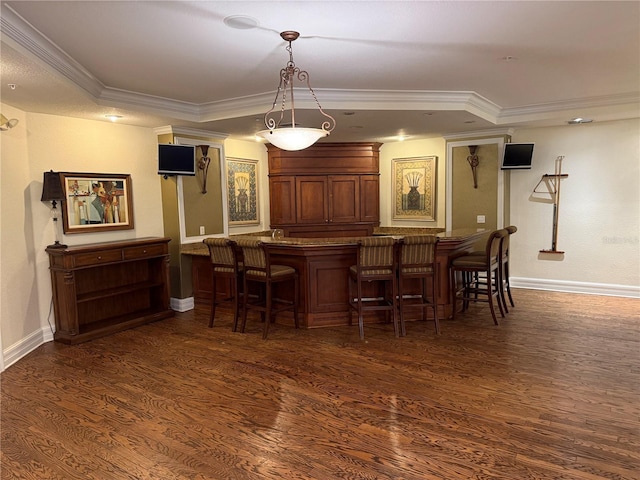 bar with hanging light fixtures, crown molding, and dark hardwood / wood-style floors