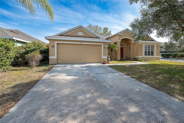 ranch-style house with a garage and a front yard