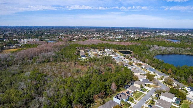 birds eye view of property with a residential view, a water view, and a wooded view